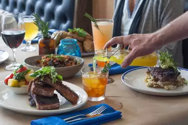The Mansion Restaurant signature dishes Steak Tartare Tacos, Windy Meadows Chicken, Braised Short Rib.